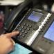 Someone hitting numbers to place a call on a landline phone.