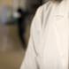Close up of a white medical jacket being worn