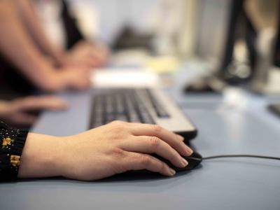 a close up of a hand holding a computer mouse 