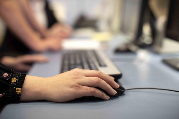 a close up of a hand holding a computer mouse 