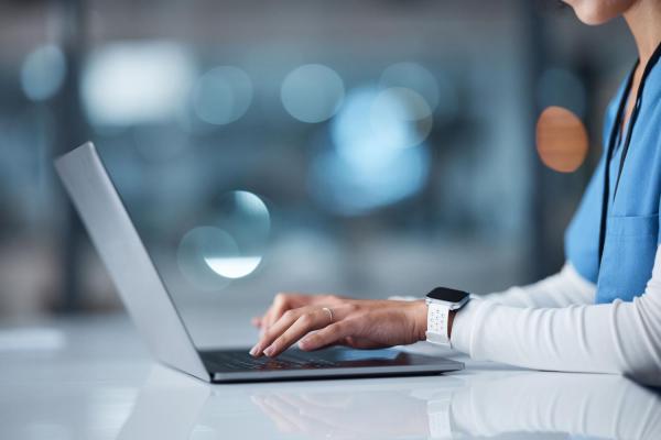 nurse on laptop typing 
